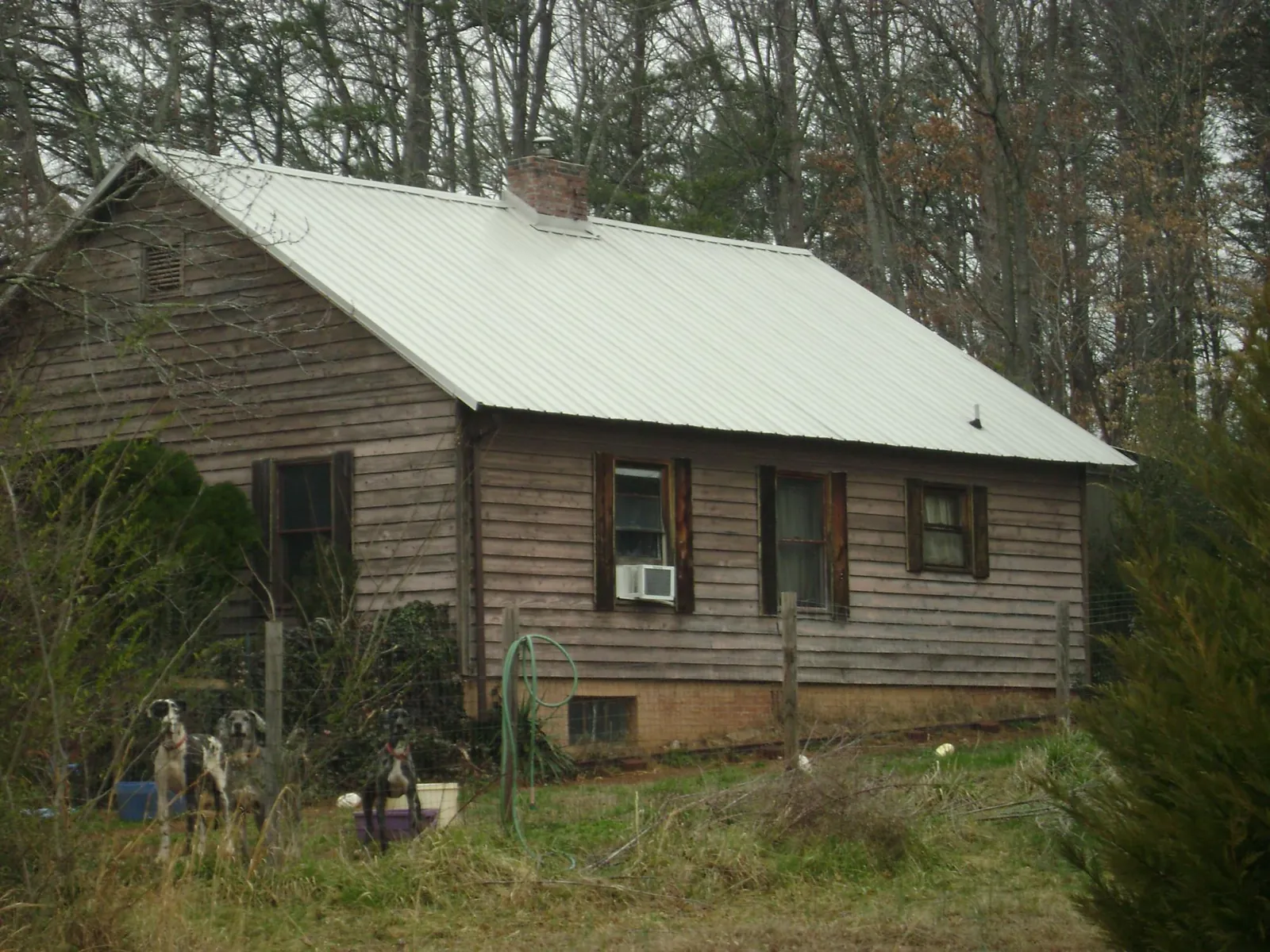 White metal roof on an old wood sided farmhouse, from a Asphalt Shingle Roof Repair job in State College